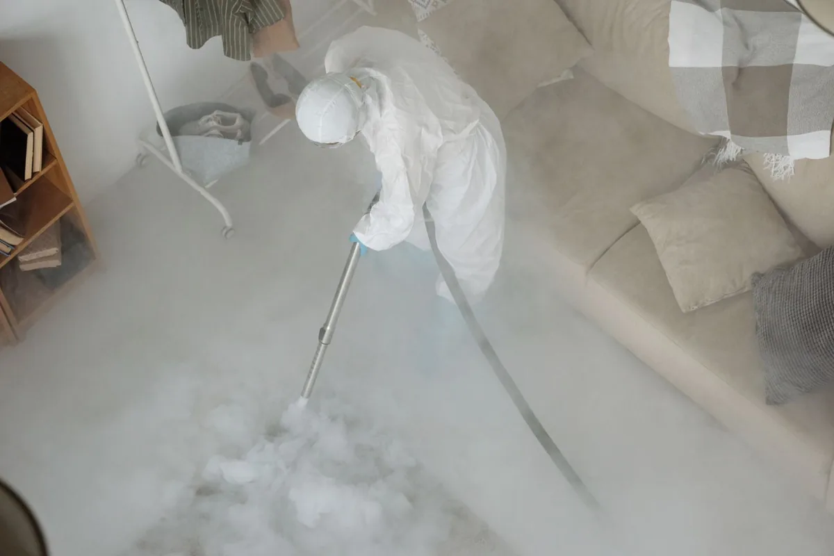 Biohazard cleanup technician in protective equipment, Inez, TX